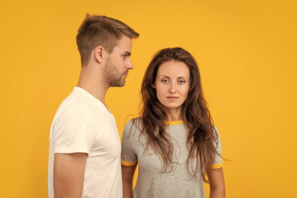 man and woman. guy and girl together. togetherness. concept of romantic relationship. fashion and beauty. stylish sexy couple on yellow background. young students. - Photo, Image
