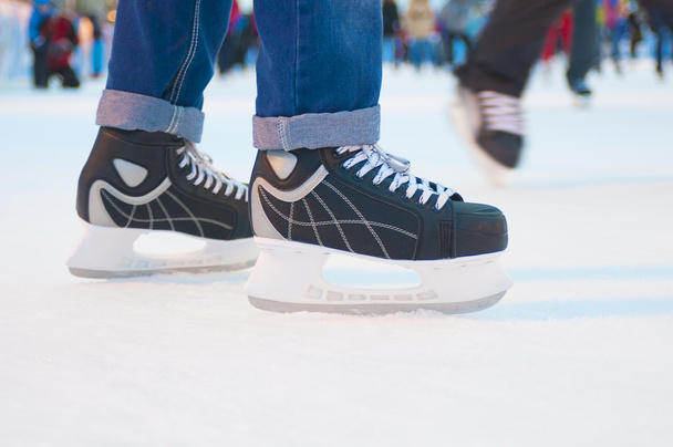 Man legs in black ice skates  - Foto, afbeelding