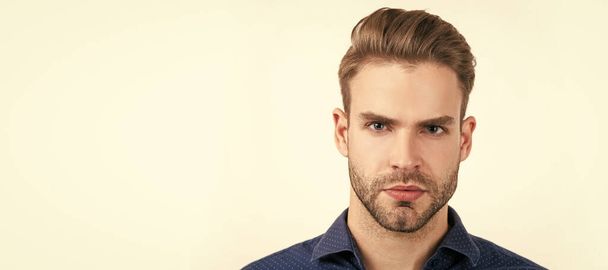 concept of mens beauty. unshaven guy in barbershop. confidence and seriousness. Man face portrait, banner with copy space - Photo, Image