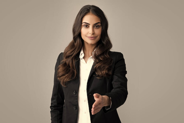 Business woman in suit smiling friendly offering handshake as greeting and welcoming. Successful business. Businesswoman giving a handshake. Friendly offering handshake as greeting and welcoming - Zdjęcie, obraz