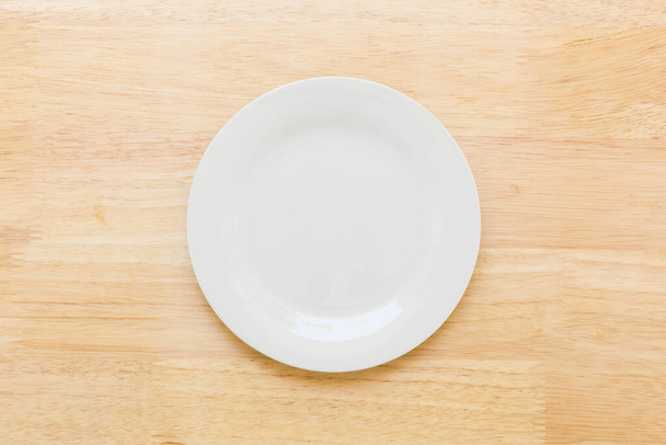 Κενό πιάτο στο τραπέζι, πάνω όψη  - Φωτογραφία, εικόνα