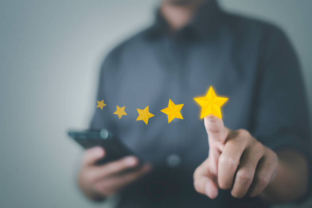 Customer service and Satisfaction concept, Business people touching the virtual screen on the star icon to give satisfaction in service. rating very impressed. - Photo, Image