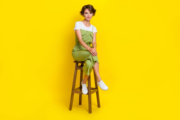 Full length size cadre of stylish cute businesswoman sitting chair crossed legs office pause weekend isolated on bright yellow color background. - Foto, imagen