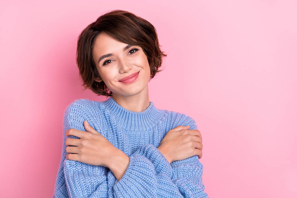 Photo of feminine pretty lady embrace herself feeling comfy enjoy warm sweater isolated on pink color background. - Fotó, kép