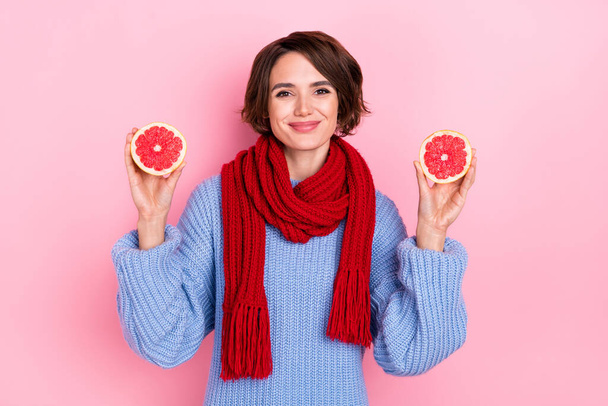 Portrait of adorable positive lady hold two half grapefruit organic eco isolated on pink color background. - Valokuva, kuva
