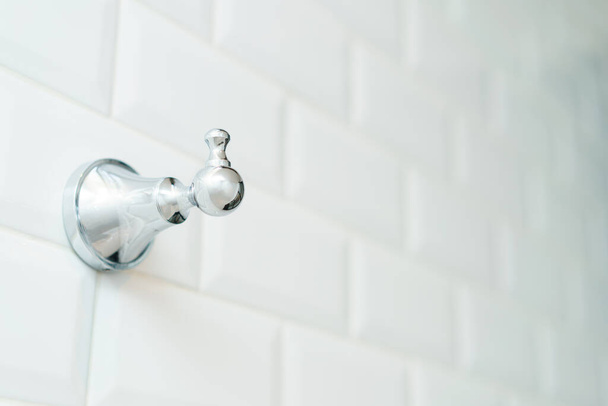 Towel metal hook on the white brick wall. - Photo, Image