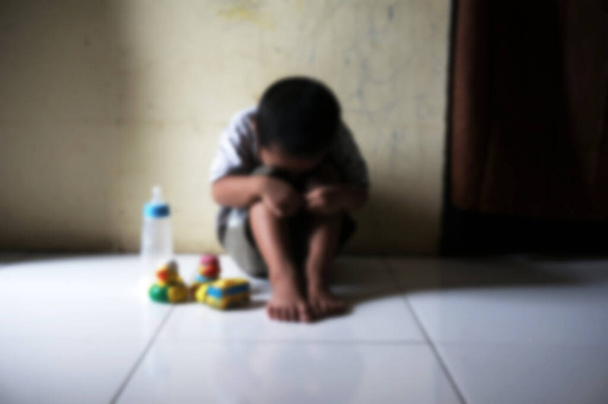 Blurred boy.  Boy covered his face with his hands. Stressed child. Domestic Family violence and aggression concept violence. concept for bullying, depression stress or frustration.                                           - Photo, Image