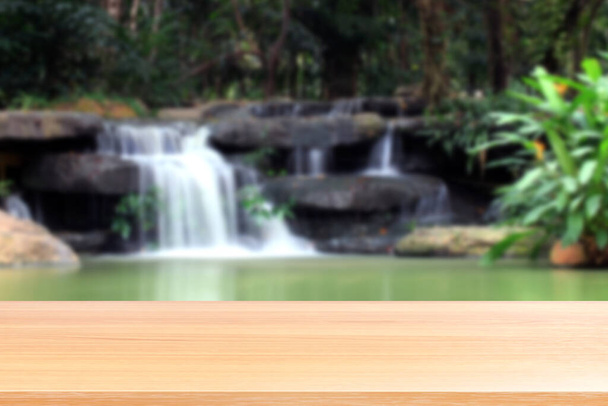 "wood plank on blurred waterfall beautiful nature background, empty wood table floors on nature waterfall fresh, wood table board empty on garden waterfall in suan luang rama IX (9) bangkok thailand" - Zdjęcie, obraz