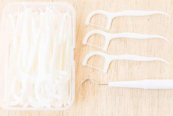 "Oral Device : A box of white dental floss on wooden background" - Photo, Image