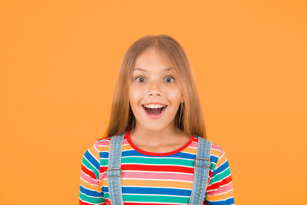 Happy childrens day. childhood happiness. cheerful hipster girl colorful clothes. optimist concept. small girl yellow background. summer kid fashion. kid positive mood. Child happiness portrait. - Foto, Bild
