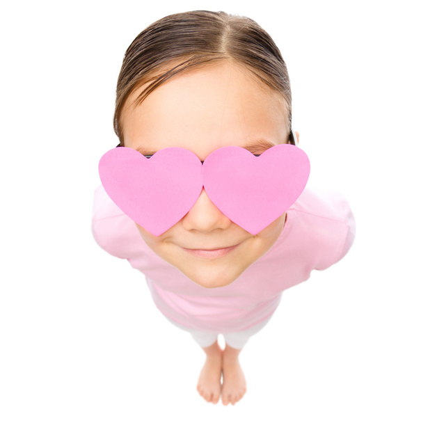 Little girl is holding hearts over her eyes - Foto, immagini