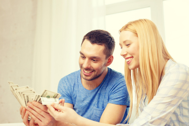 couple with money at home - Foto, Bild