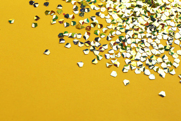 Shiny bright glitter on yellow background. Space for text - Photo, image