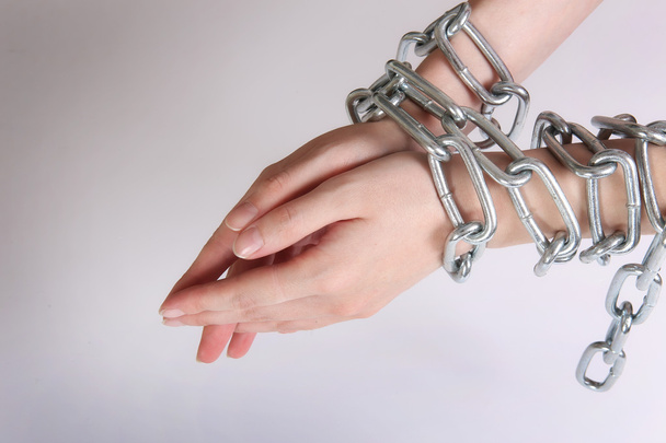 female hands tied by chain - Foto, imagen