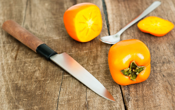 Fresh ripe persimmon on a wooden table - Foto, Imagem