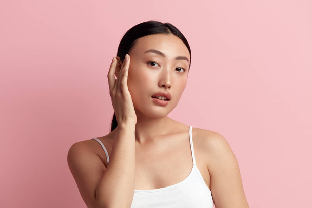 Tender Woman Touching Chick. Portrait of Positive Asian Woman Touching her Face and Smiling. Woman Appearance and Skin Care Concept  - Photo, Image