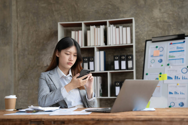 asian woman thinking hard concerned about online problem solution looking at laptop screen, worried serious asian businesswoman focused on solving difficult work computer task.. - 写真・画像