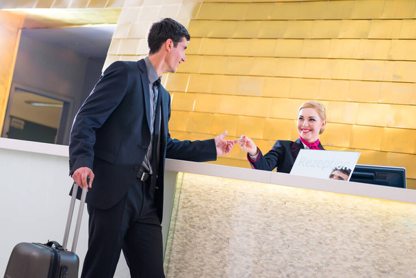 "Hotel receptioniste inchecken man die geeft key-card" - Foto, afbeelding