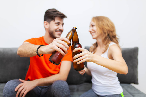 "ζευγάρι με μπουκάλια μπύρας ζητωκραυγάζουν" - Φωτογραφία, εικόνα