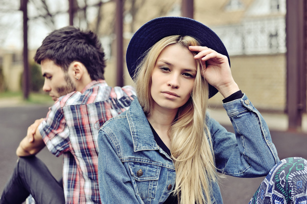 Depressed couple. Depressed young hipsters couple sitting back t - Photo, Image