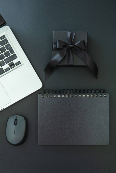 Cyber Monday and Black Friday Sale. Gift box, computer laptop and empty cover notebook on office desk, top view. - 写真・画像