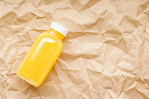 Fresh orange juice in eco-friendly recyclable plastic bottle and packaging, healthy drink  - Photo, Image