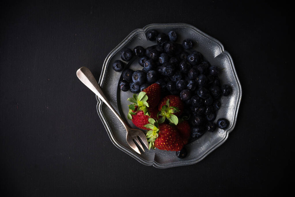 close-up shot of fresh organic berries on tabletop for background - Фото, изображение