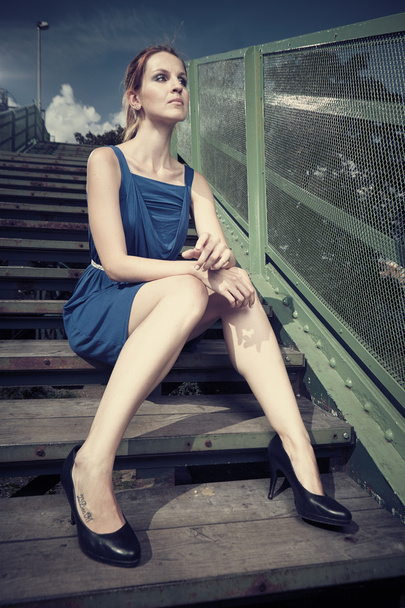 Woman sitting on stairs - Fotó, kép
