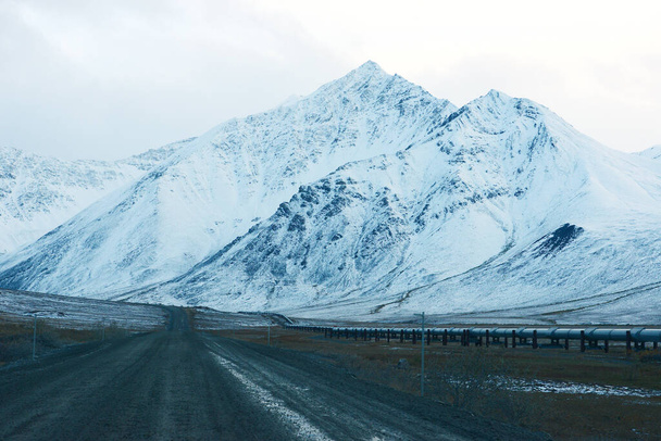 View of Dalton highway, snowy mountains and blue sky - Photo, Image