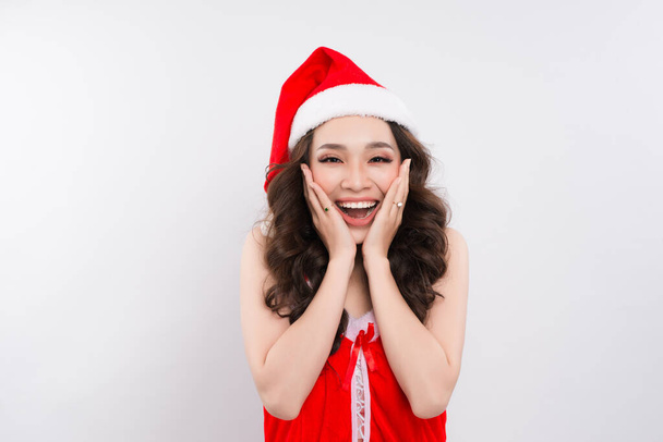 beautiful smiling female asian model wear santa hat - Foto, afbeelding