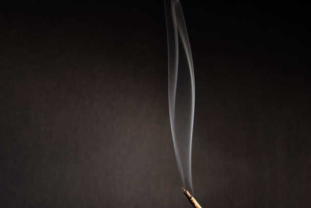 incense stick with smoke against black background - Foto, Imagen
