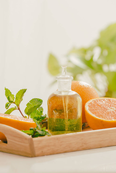 "Tangerine oil on table on light background" - Photo, Image
