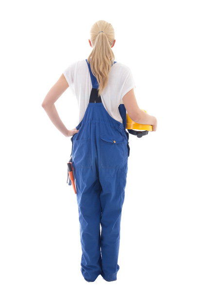 назад точка зрения счастливой женщины в синей униформе строителя удерживание желтого  - Фото, изображение