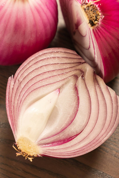 two red onions close up on wooden background - Φωτογραφία, εικόνα