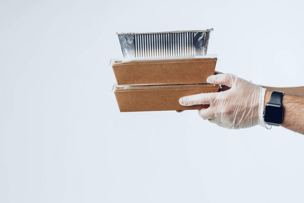 "Courier hands in latex gloves giving packed food delivery" - Foto, Imagen