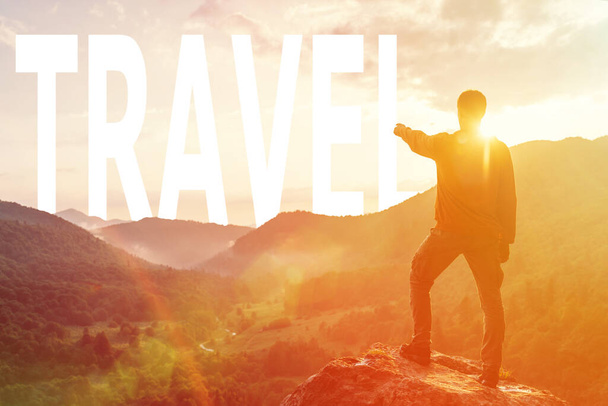 "Man pointing at word travel in mountains at sunset." - Photo, Image