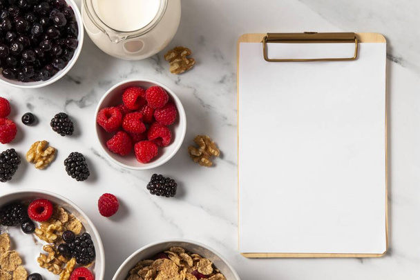 composition healthy bowl cereals with berries with empty clipboard - Foto, afbeelding