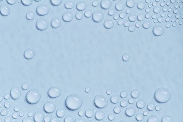 Big and small water drops on blue background. Closeup - Zdjęcie, obraz