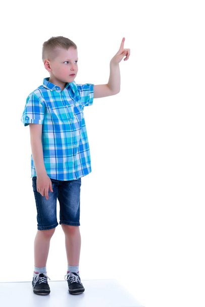 The boy points a finger at something. - Photo, Image