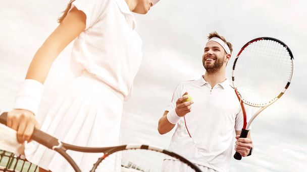 "They play like a team. Young couple is playing tennis" - Fotoğraf, Görsel