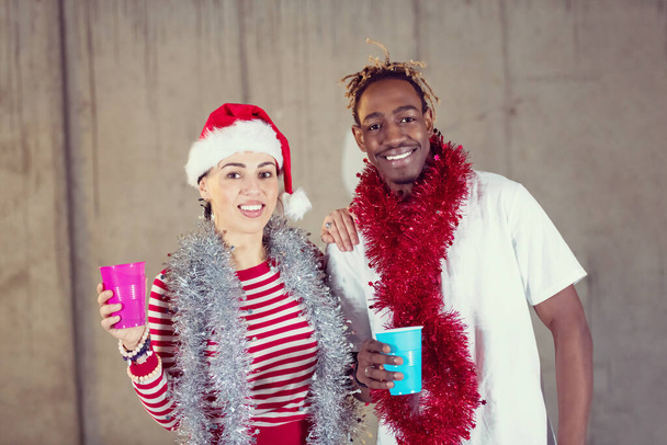 young multiethnic business couple celebrating new year party - Фото, изображение