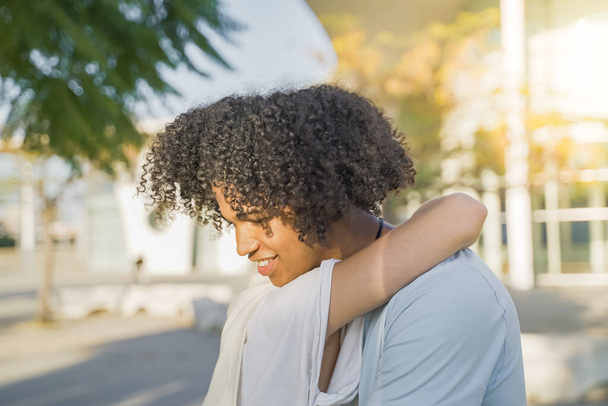 Friendly hug concept, smiling millennial black man and woman cuddling, friendship and good warm relations. High quality photo - Fotografie, Obrázek