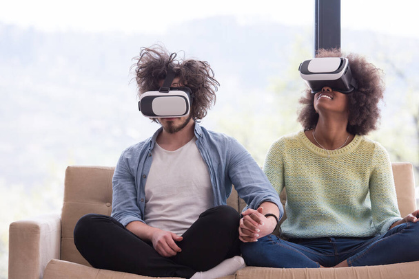 Multiethnic Couple using virtual reality headset - Фото, изображение