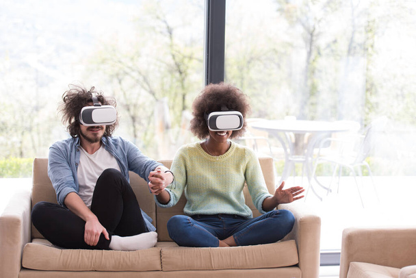 "Multiethnic Couple using virtual reality headset" - Photo, Image