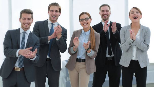 smiling business team applauds their success - Photo, image