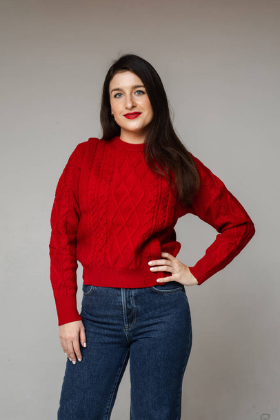 "cheerful woman in red sweater and blue jeans" - Photo, image