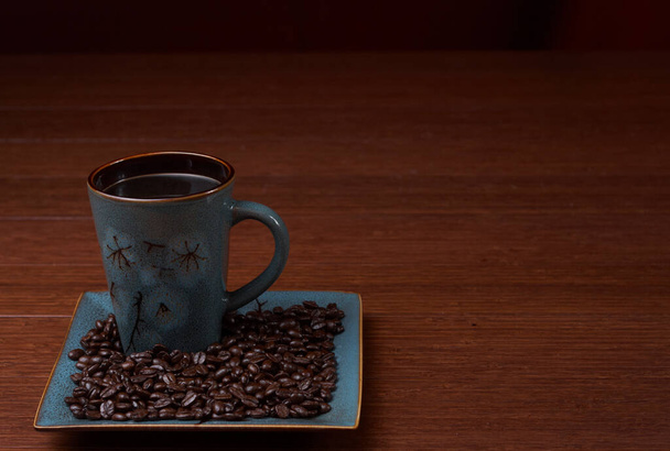  a cup of coffee with coffee beans - 写真・画像