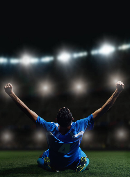 soccer player in front of big modern stadium with flares and lights - Foto, Imagen