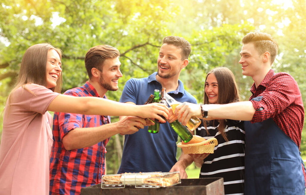"Friends toasting beer at barbecue in nature." - Photo, Image