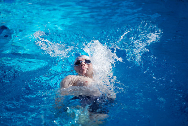 swimmer exercise on indoor swimming pool - Foto, afbeelding
